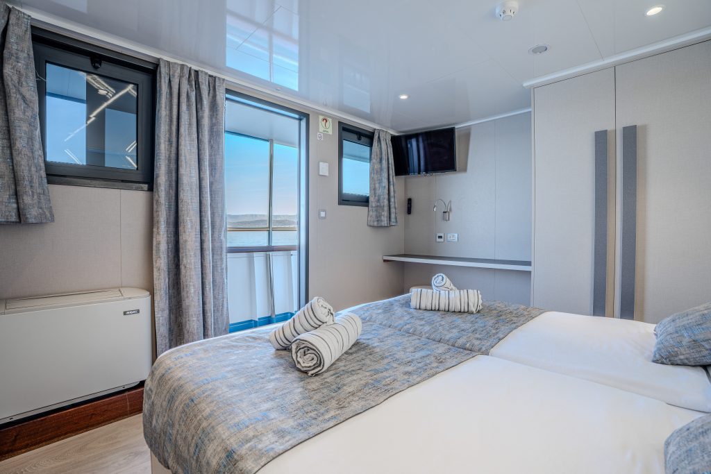 Bright and modern main deck cabin aboard a Zantium Travel small-ship cruise in Croatia, featuring large windows, sea views and a comfortable interior.