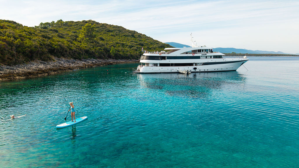 Small cruise ship anchored during a swim stop on the Croatian coast